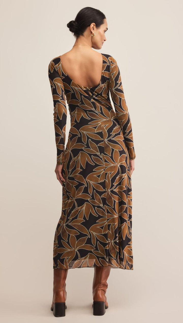Brown and green leaf print wrap dress with long sleeves.