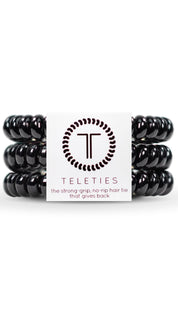 Black spiral hair ties with a circular logo featuring the letters ’tt’ in white and dark gray.