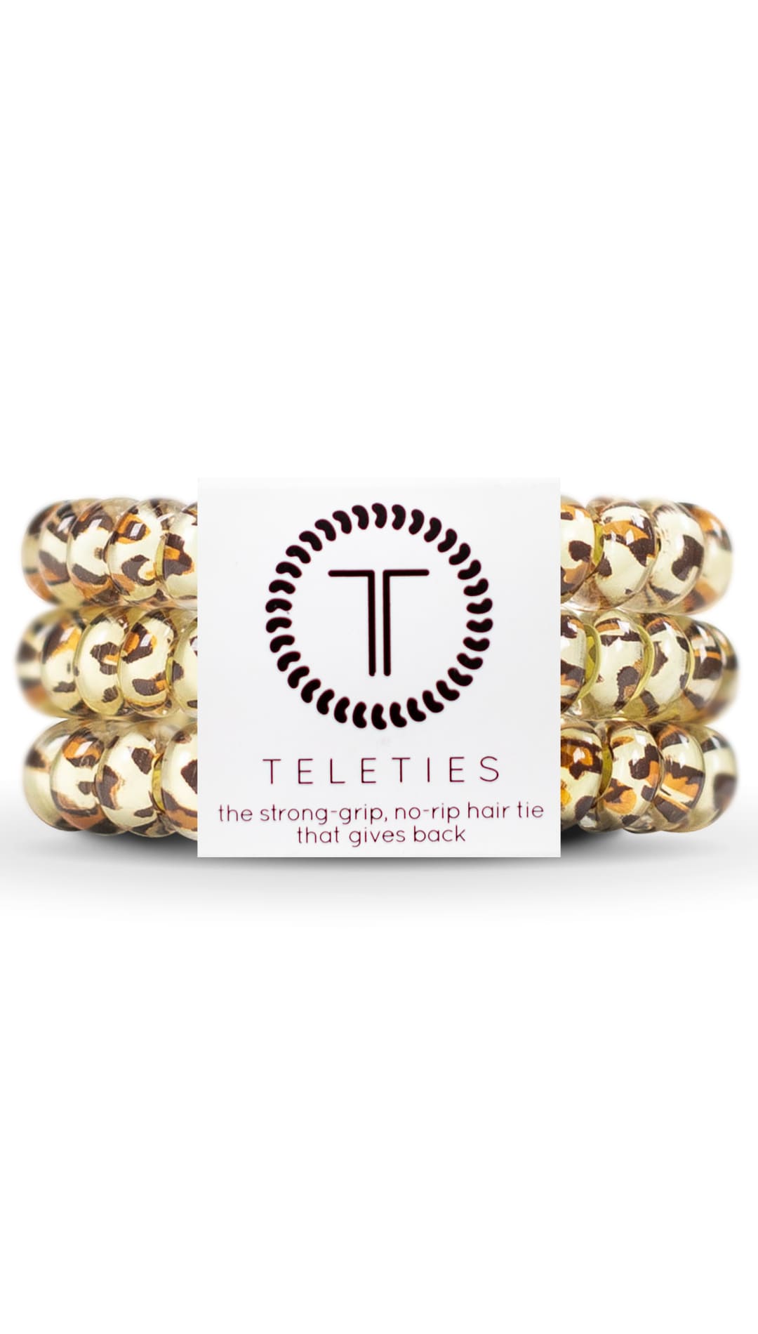 Gold and brown hair ties with a circular logo featuring the letters ’tt’ in black.