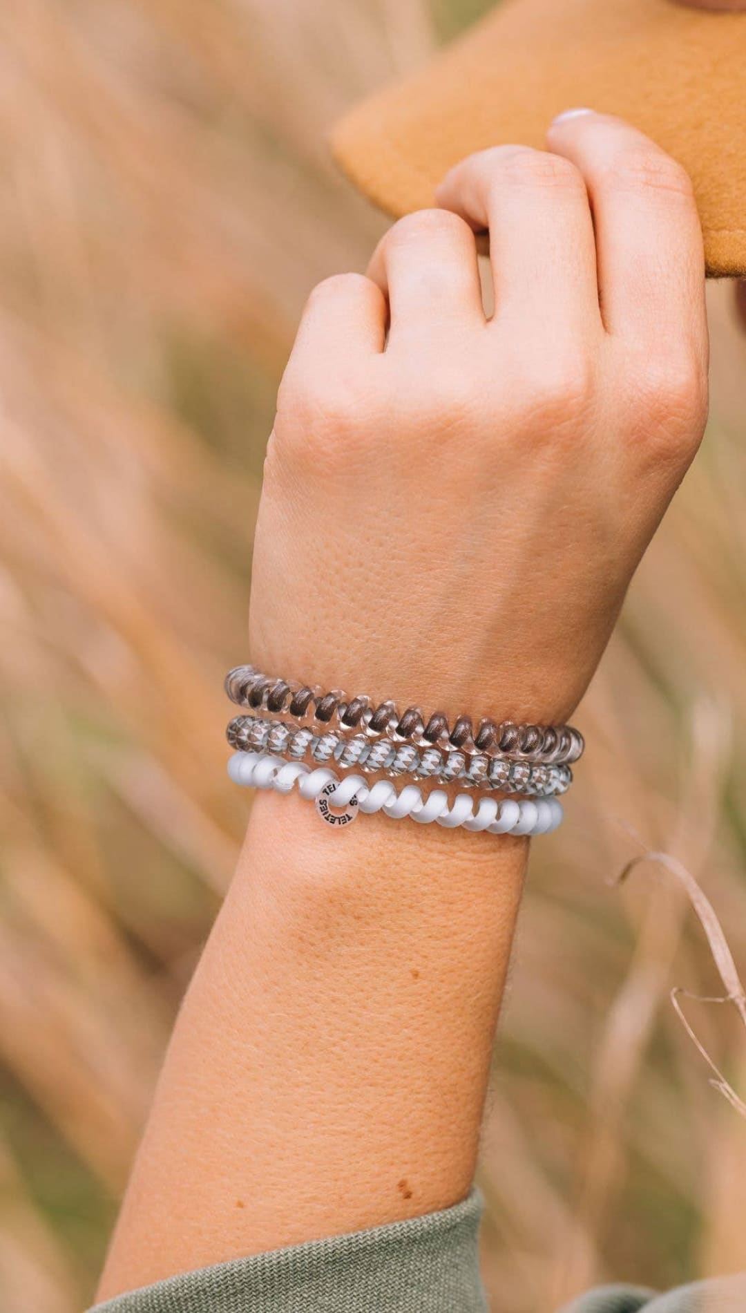 Multi-layered silver and white beaded bracelet with a bohemian design.