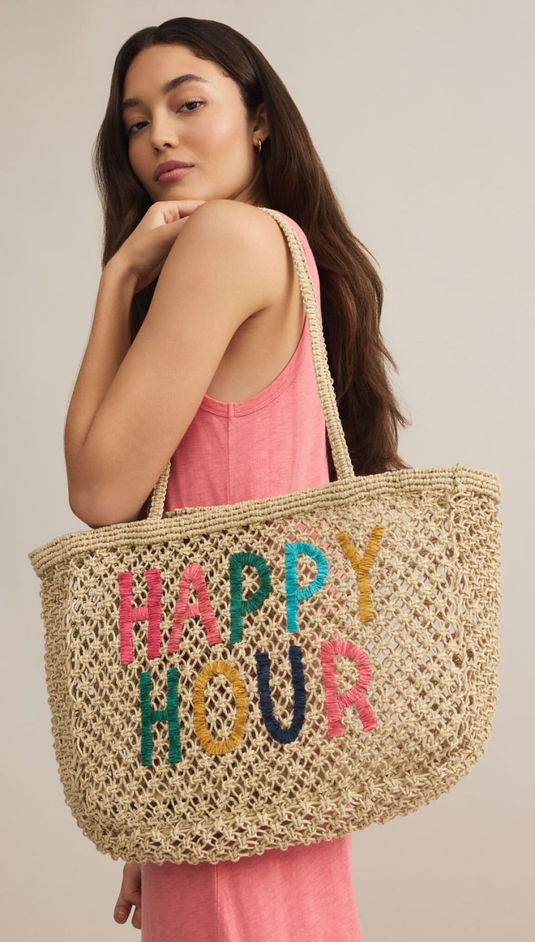Woven tote bag with colorful lettering.
