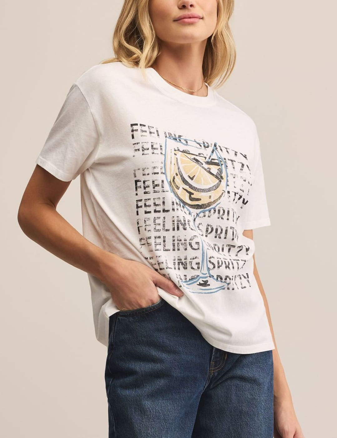 Woman wearing a graphic tee and jeans.