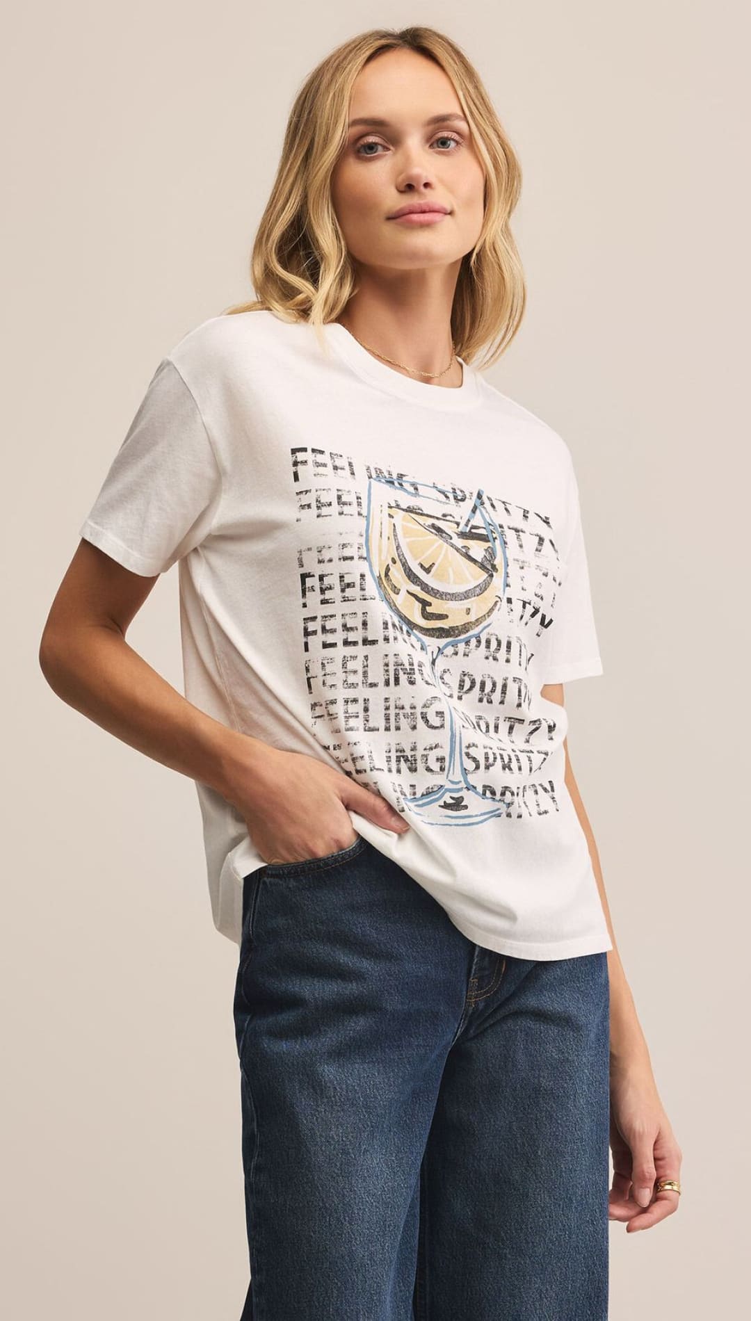 Woman wearing a graphic tee and jeans.