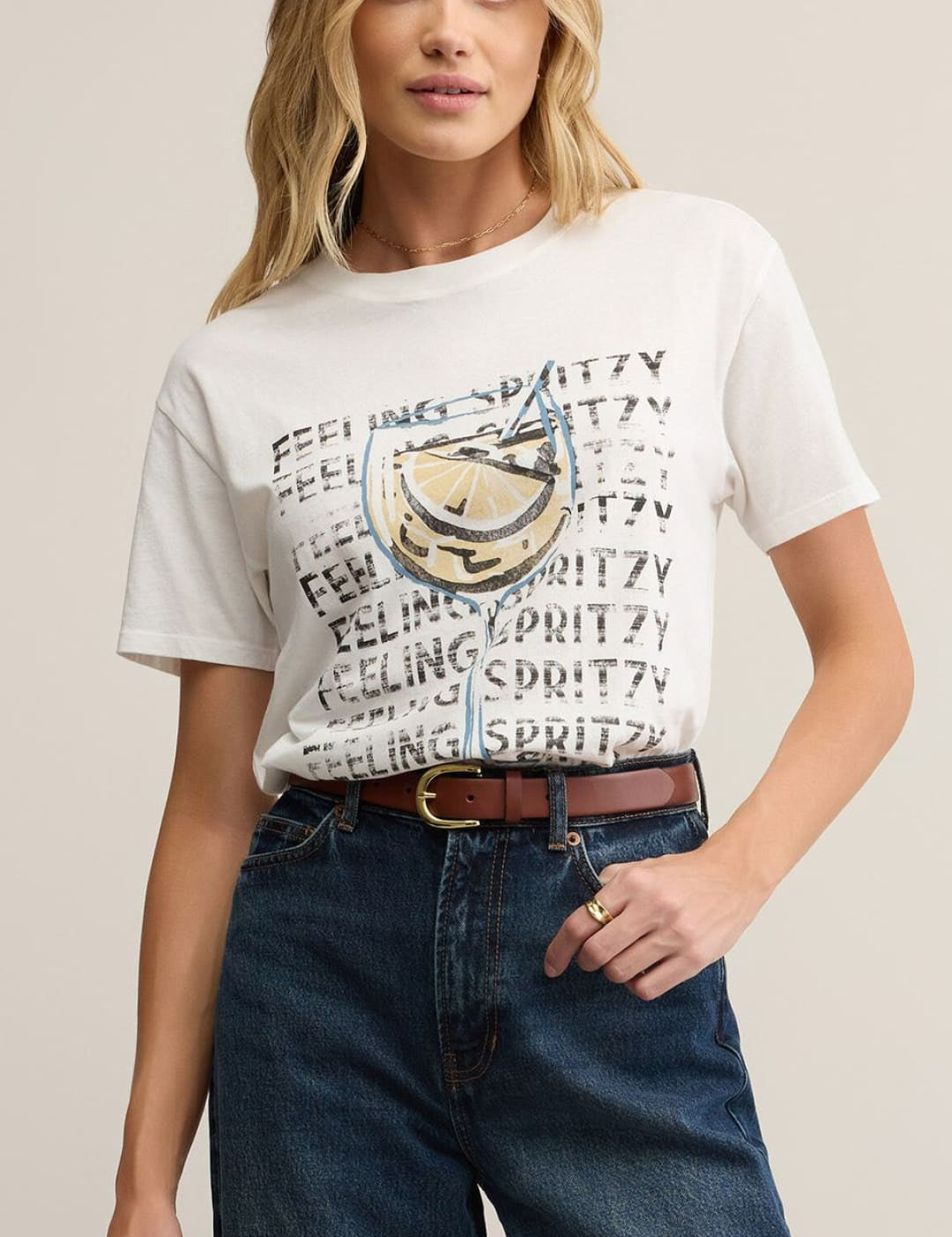 Woman wearing a graphic t-shirt and jeans.