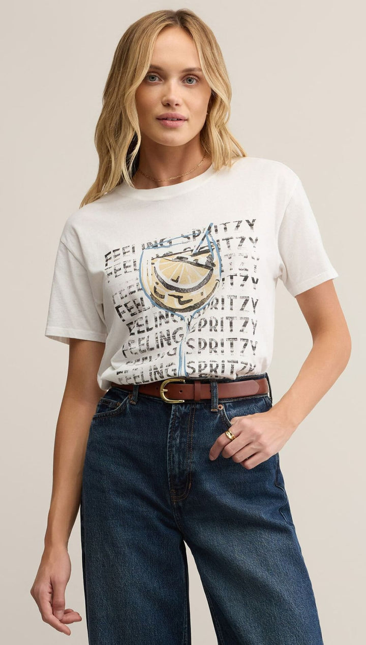 Woman wearing a graphic t-shirt and jeans.