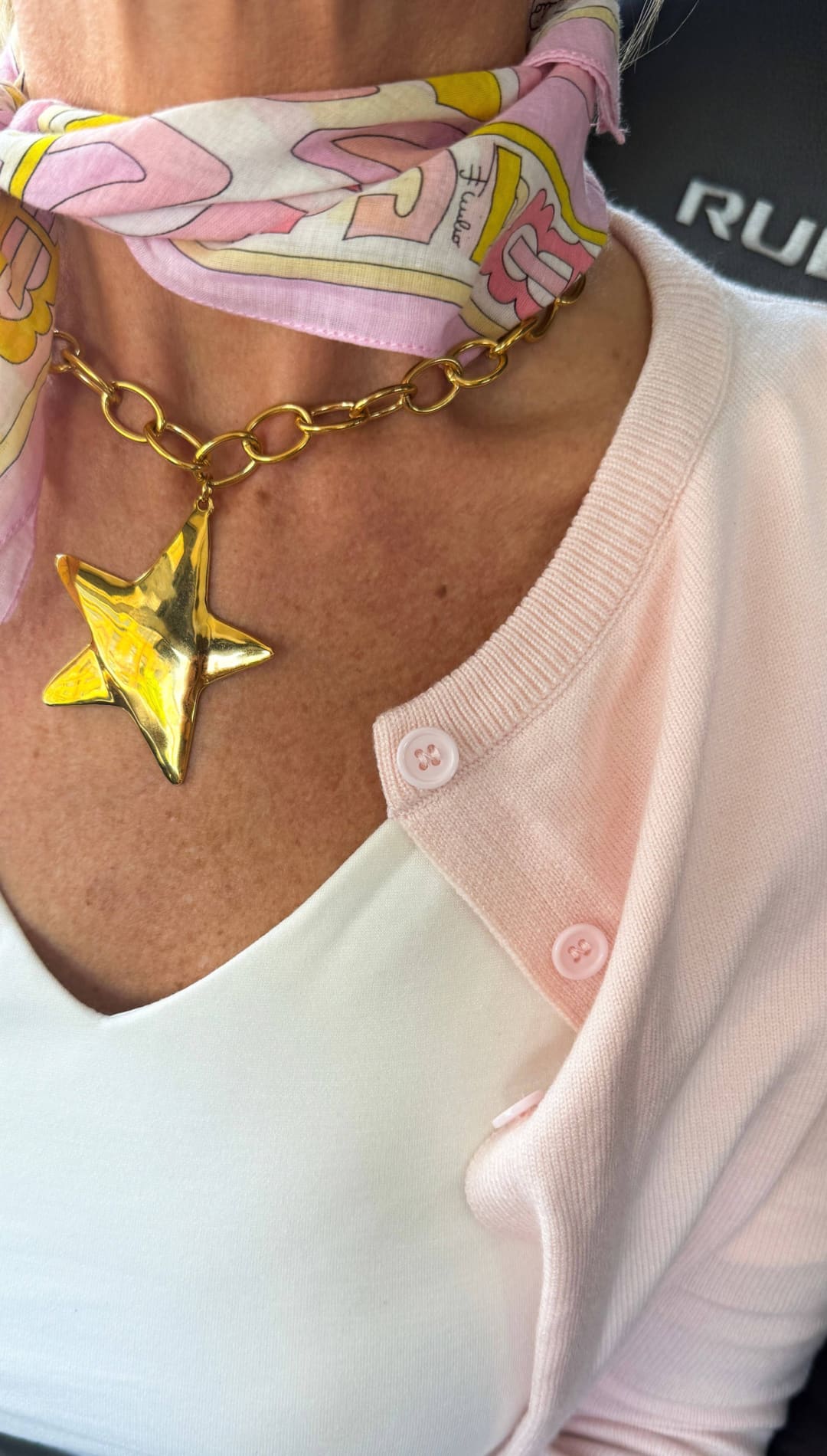 Gold star pendant necklace with a chunky chain.
