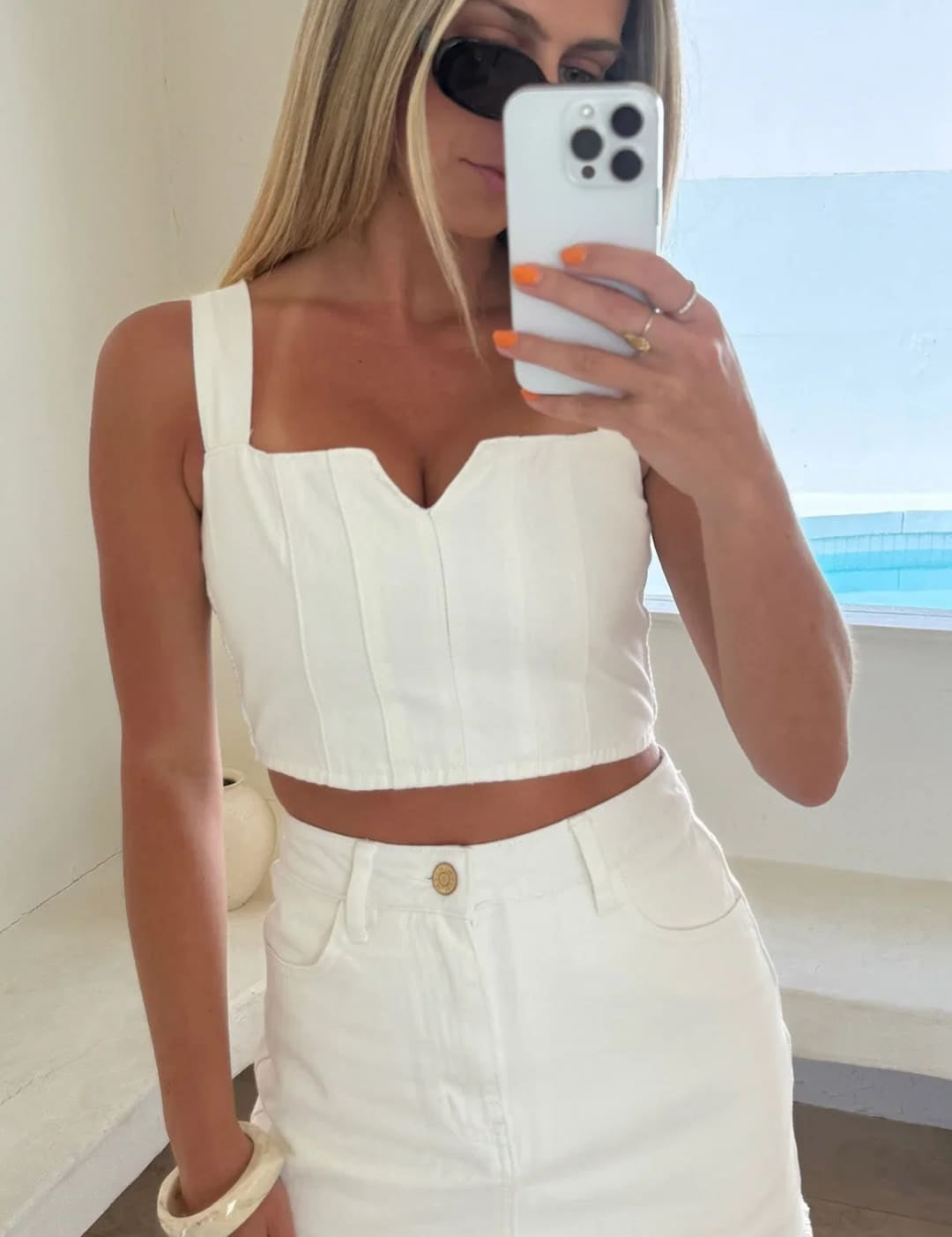 Woman in white two-piece outfit.