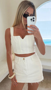 Woman in white two-piece outfit.