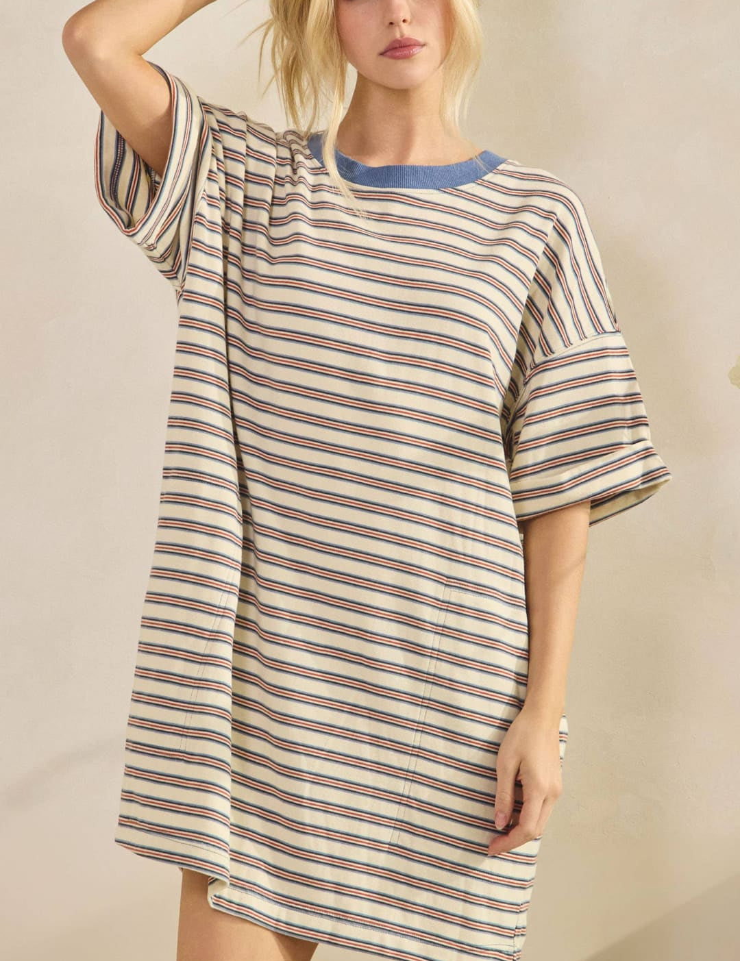 A loose-fitting, off-white and navy blue striped nightdress with a contrasting solid blue crew neckline.