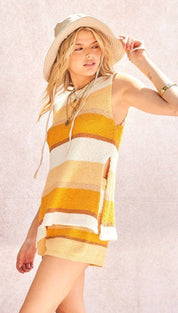 A cozy, sleeveless knit dress in horizontal stripes of mustard yellow and cream with a textured weave.
