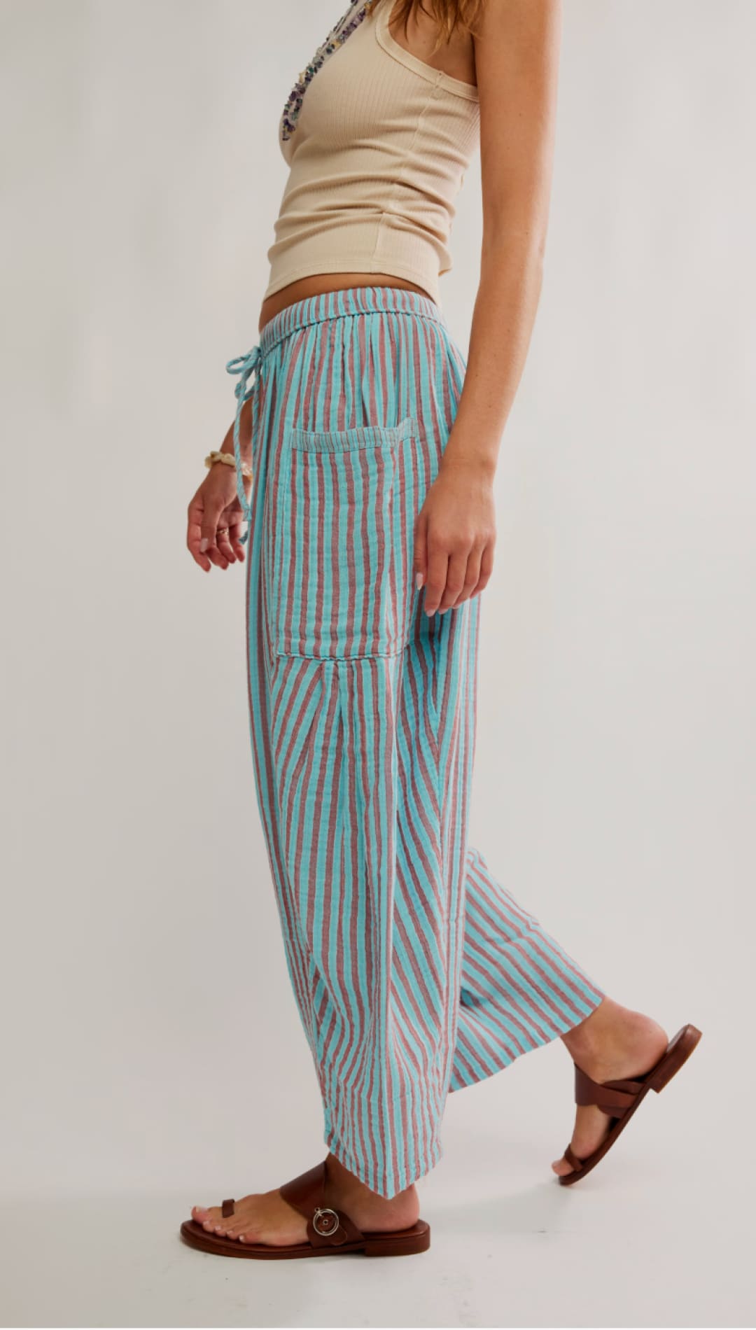Light blue and pink vertically striped wide-leg pants with a drawstring waistband.