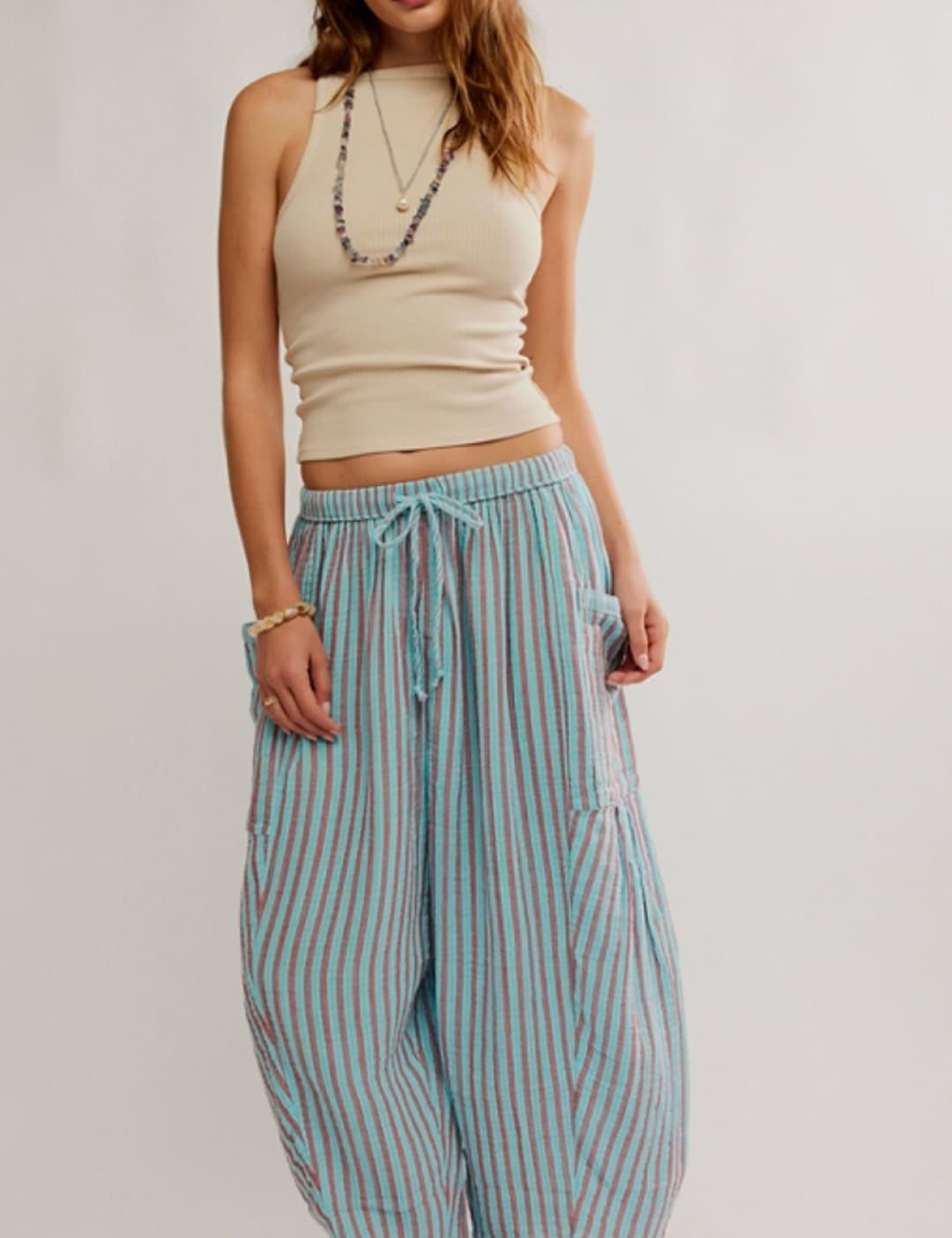Light blue and white vertically striped wide-leg pants with a drawstring waist.