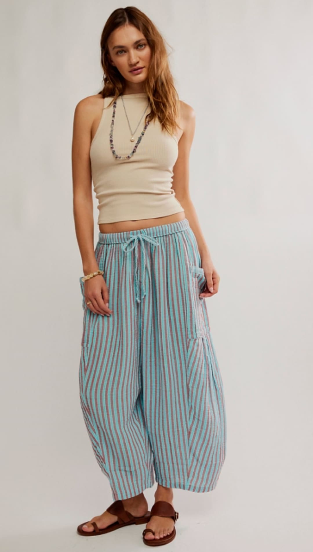 Light blue and white vertically striped wide-leg pants with a drawstring waist.