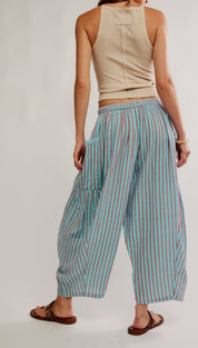 Striped wide-leg pants in a soft teal and muted pink pattern, crafted from lightweight fabric with an elastic waistband.