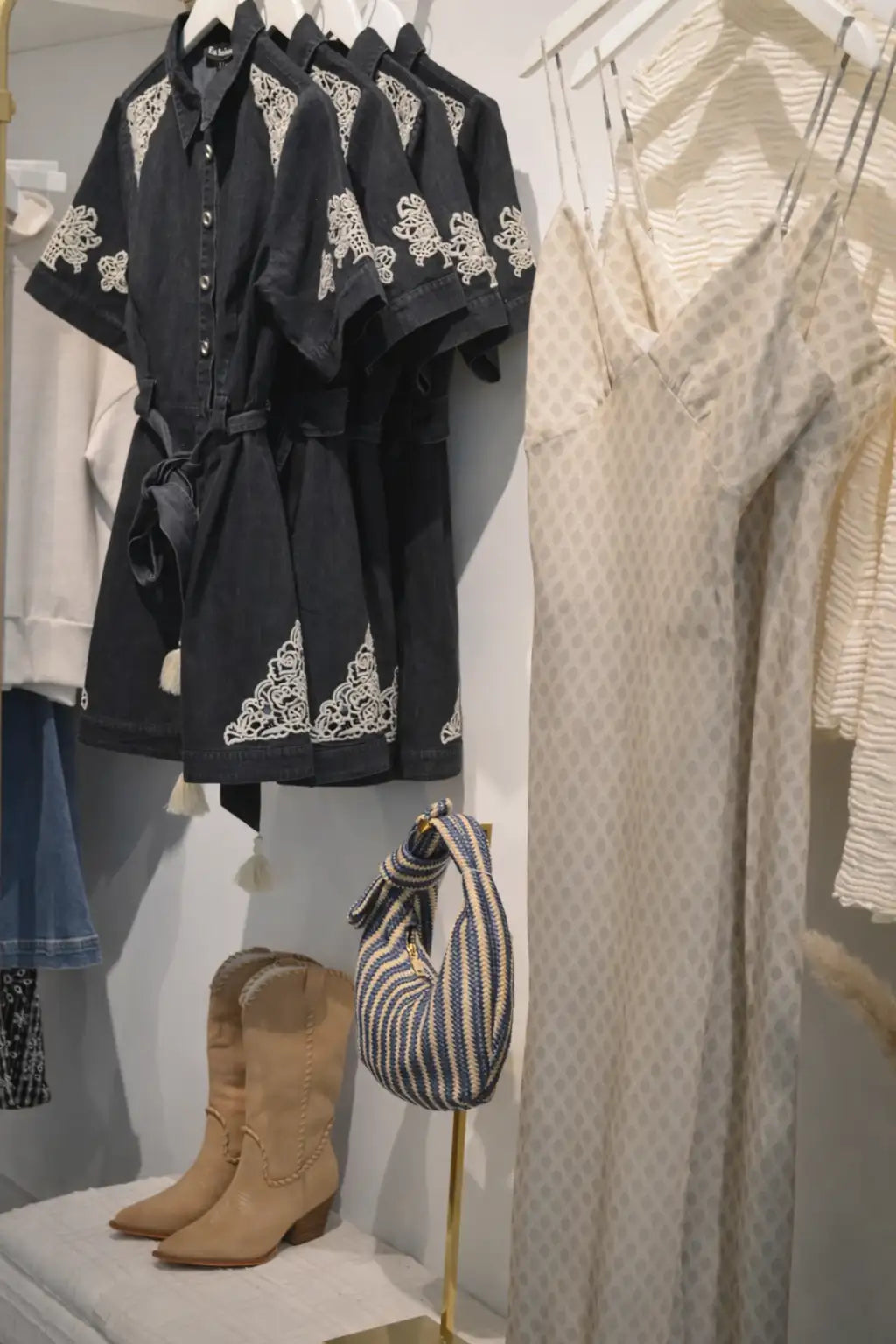 A striped woven handbag with a knotted top handle and tassel details.