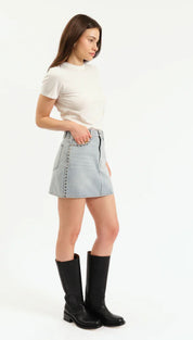 A light blue studded denim mini skirt.