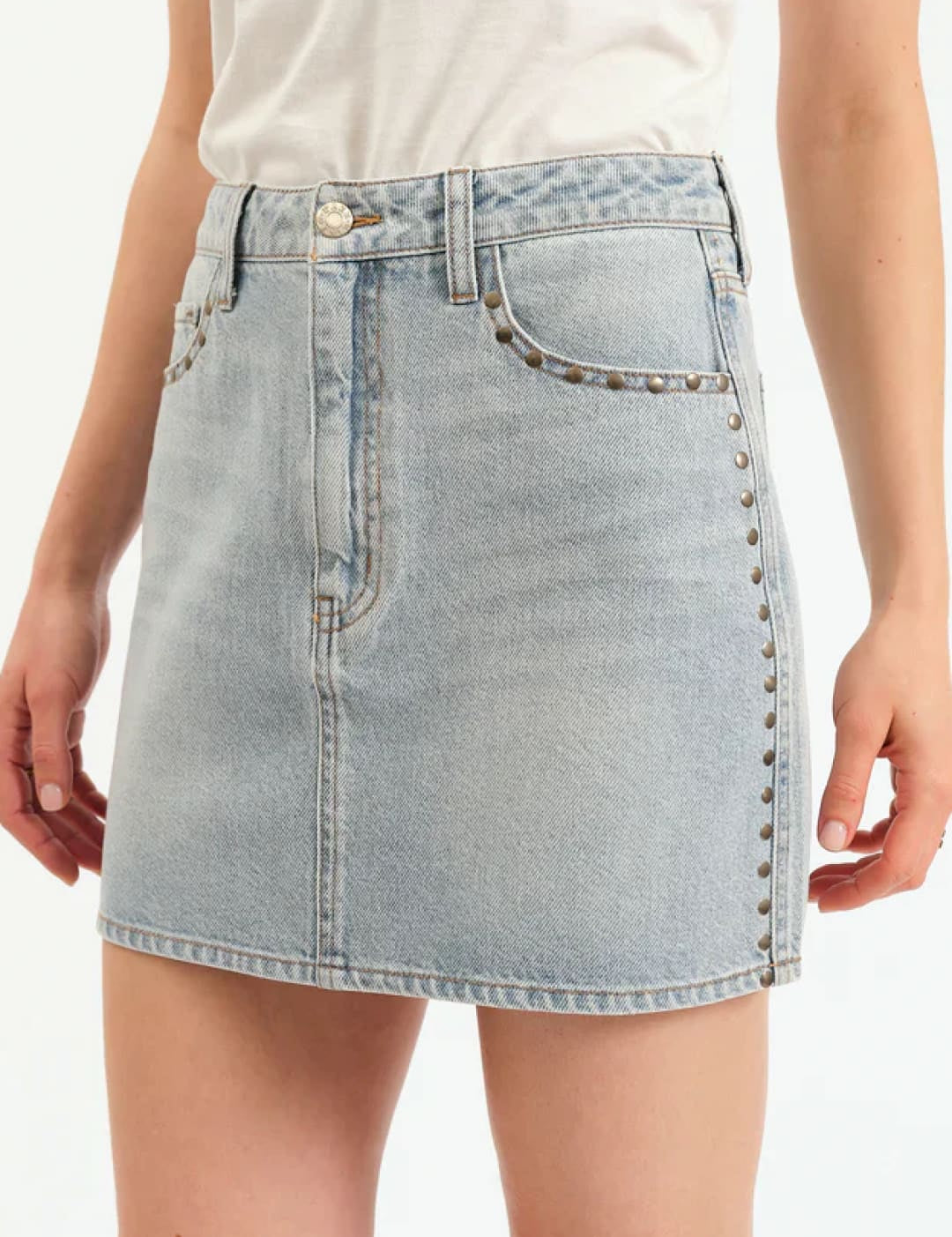 Light wash denim mini skirt with stud embellishments.