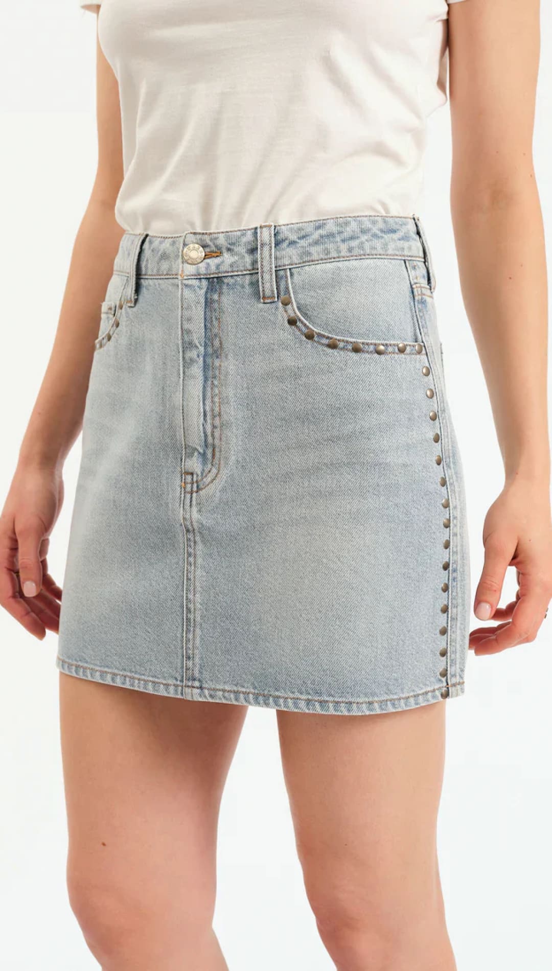 Light wash denim mini skirt with stud embellishments.