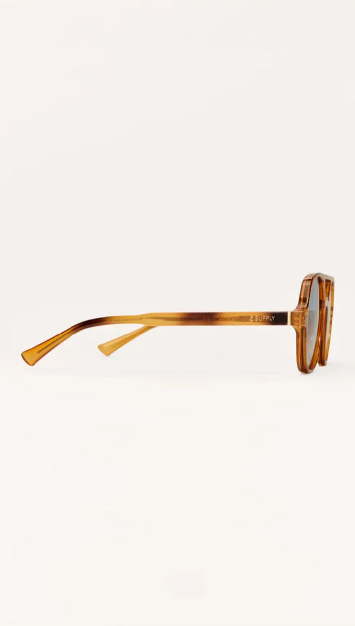 Tortoiseshell acetate sunglasses with round lenses and gold accents.