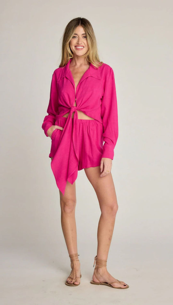 Woman in a pink shirt and shorts.