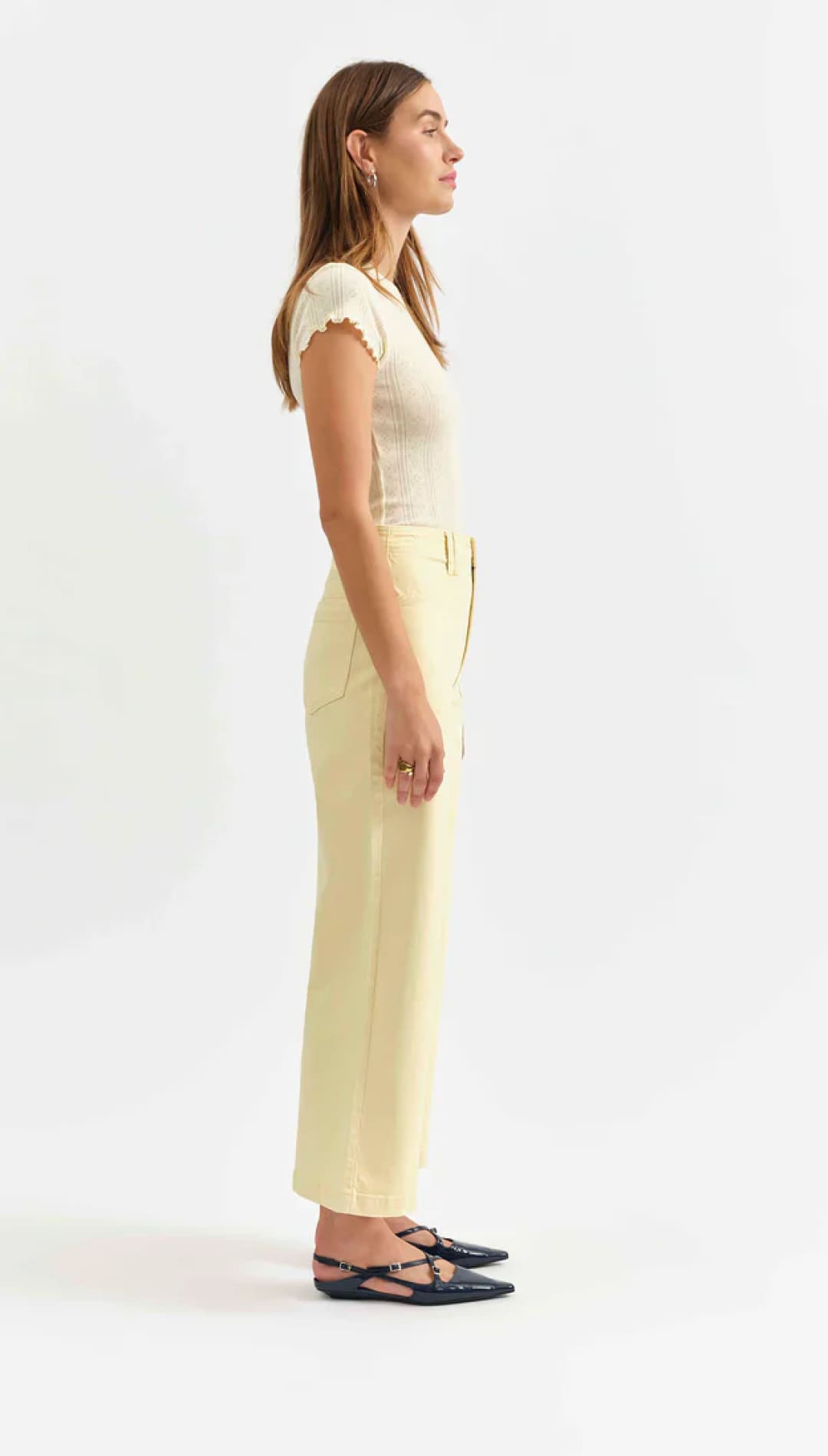 Woman in a light-colored outfit.