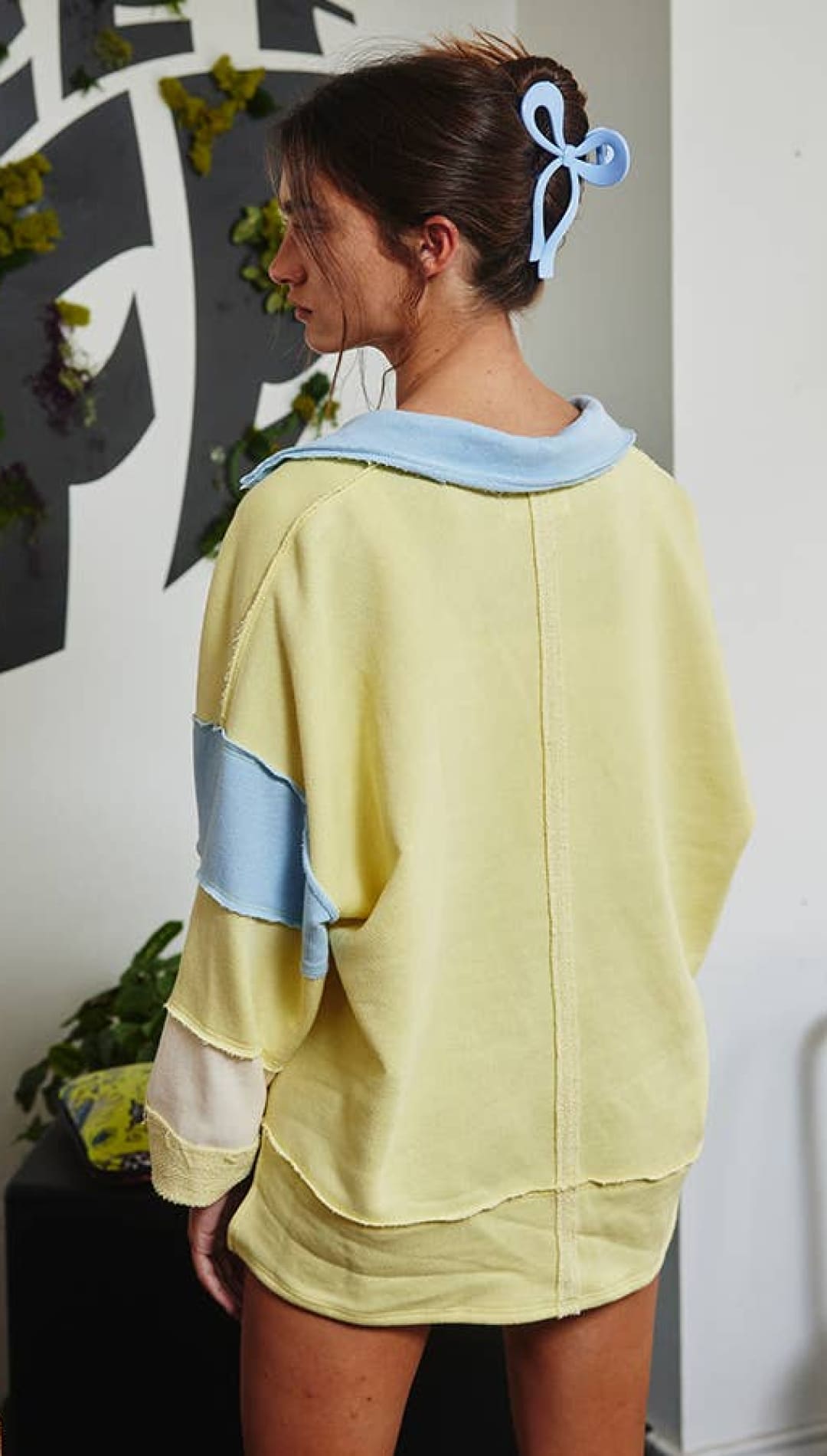 Pastel patchwork hoodie with hood and drawstring, made of soft cotton blend.