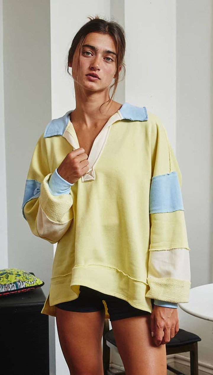 Yellow and blue patchwork hoodie with a relaxed fit.