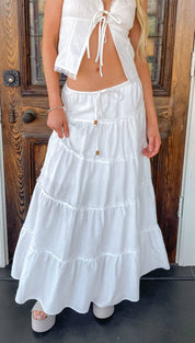 White tiered maxi skirt with ruffled layers and a drawstring waist.
