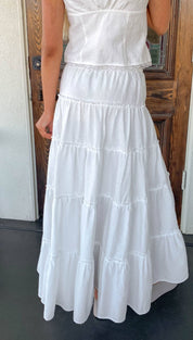 White tiered maxi skirt with delicate lace trim at the waist.