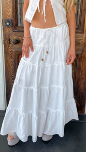 White tiered maxi skirt with ruffled layers and a drawstring waist.