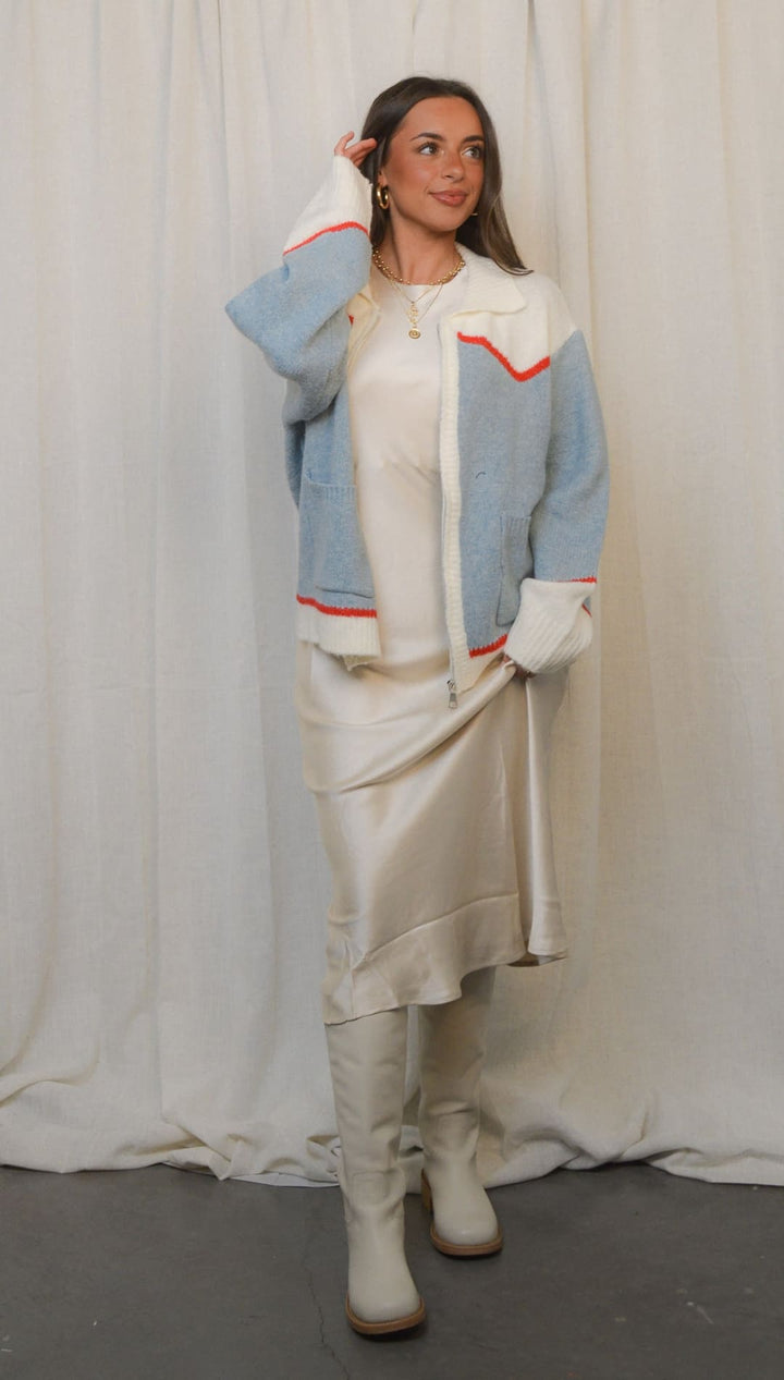 Light blue and white color block jacket with red trim.