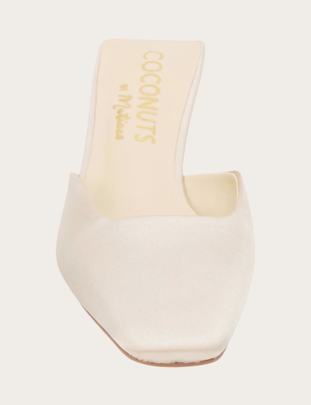 Cream-colored square-toe mule.