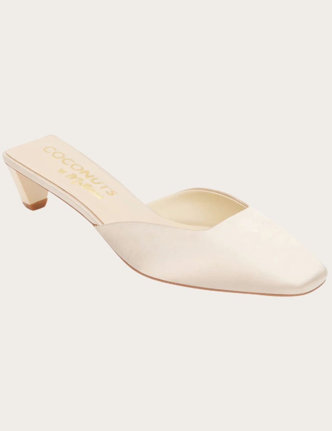 Elegant ivory mule with a low heel.