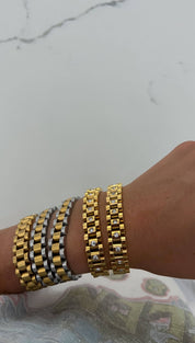 Gold and silver two-tone bracelet with a classic link design, featuring embedded clear stones.