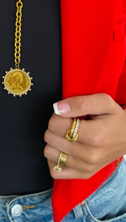 Gold coin pendant necklace with a beaded border and chain.