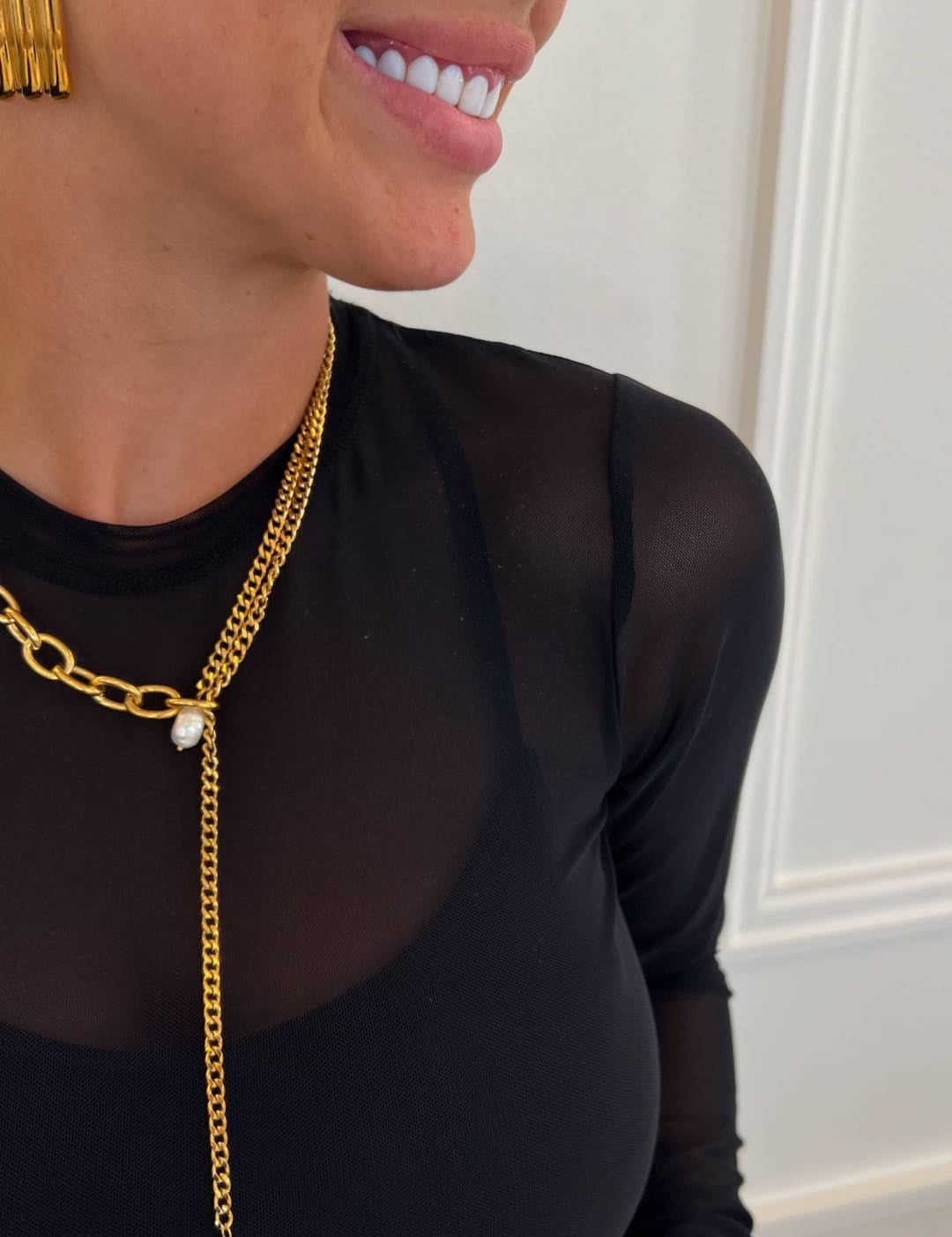 Gold chain necklace with a central pearl pendant and matching gold bar earrings.