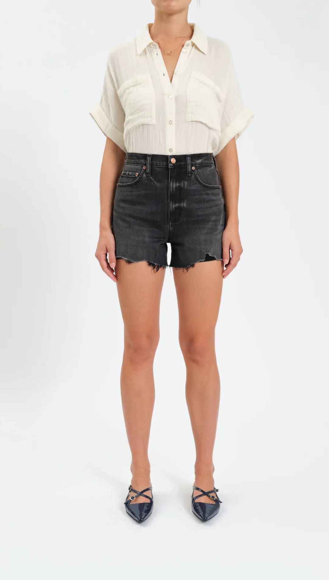 Black distressed denim shorts with raw hem detailing.