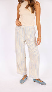 Wide-leg striped trousers in a soft cream and light blue vertical stripe pattern, made from lightweight fabric with an elastic waistband