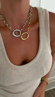 A two-tone chain necklace featuring interlocking silver and gold-toned circular links.