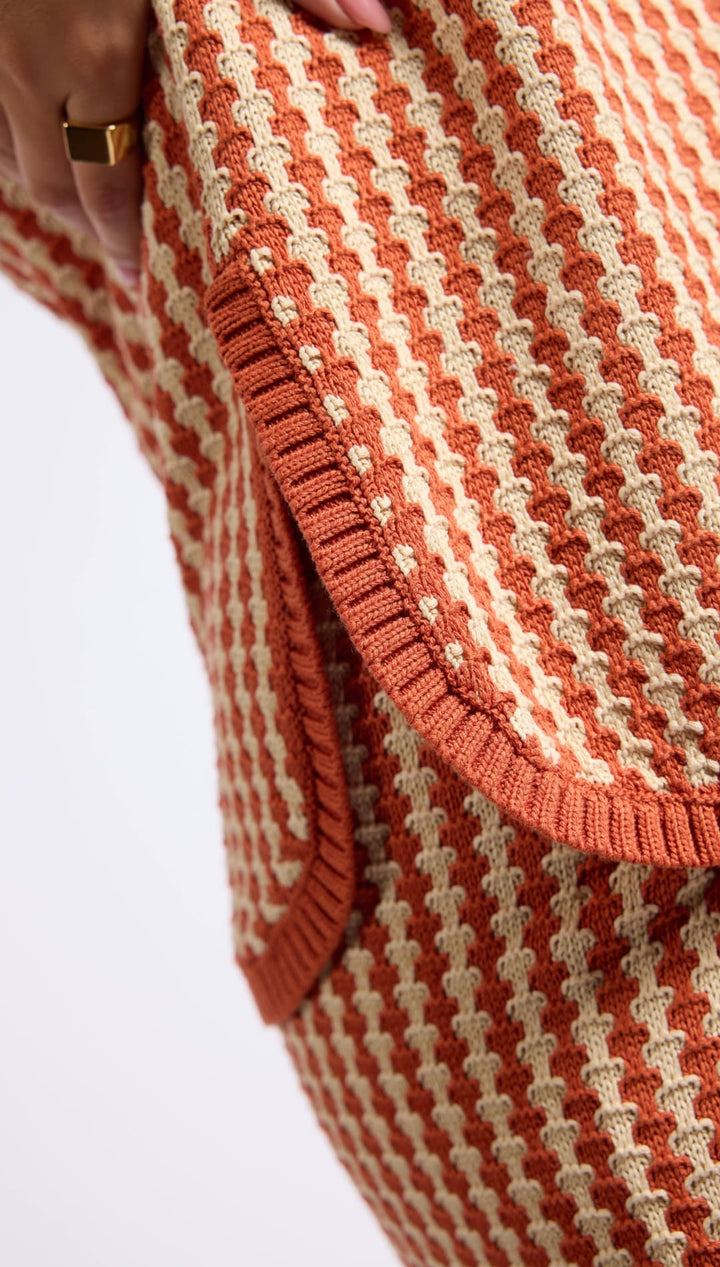 Orange and beige textured knit garment.