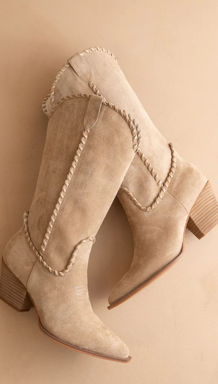 Beige suede cowboy boots with braided detailing and a block heel.