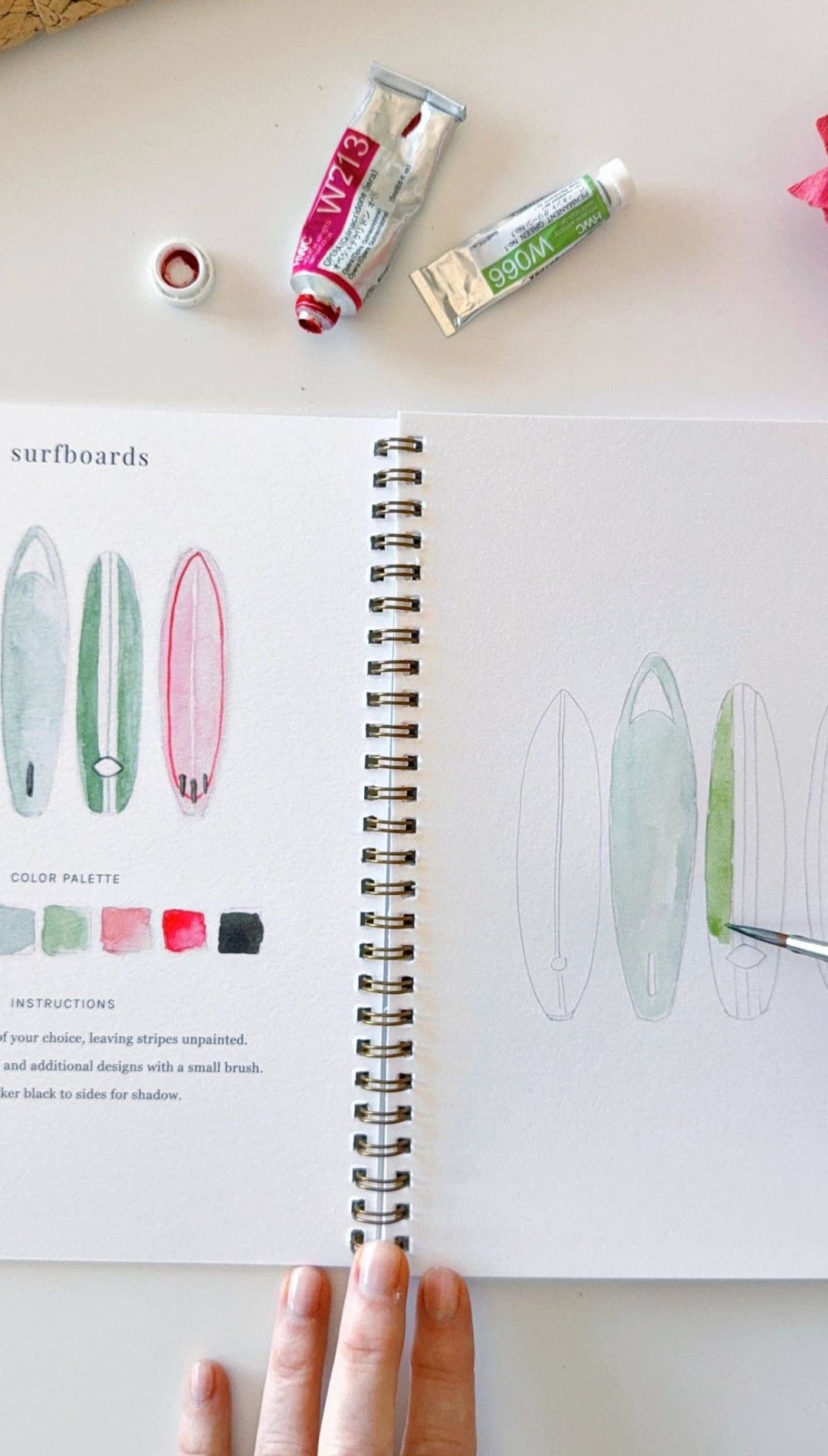 Watercolor paint set with vibrant colors and tubes of acrylic paints.