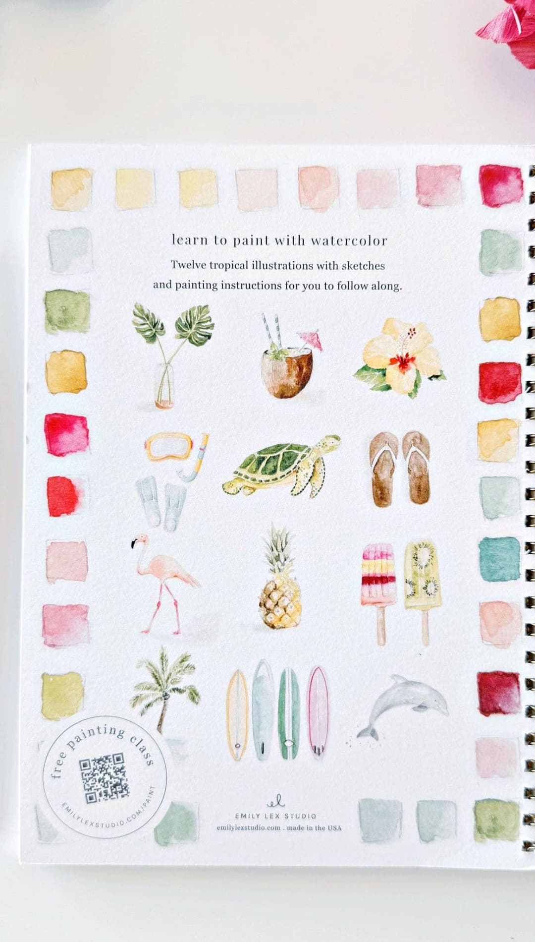 Watercolor painting book with tropical illustrations and color swatches, spiral-bound cover in white.