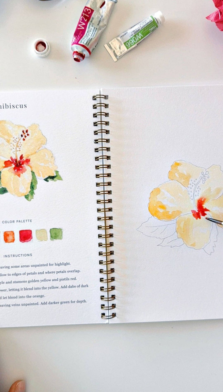 Watercolor painting book with hibiscus flower illustration and color palette guide.