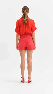 Woman in red shorts and shirt.