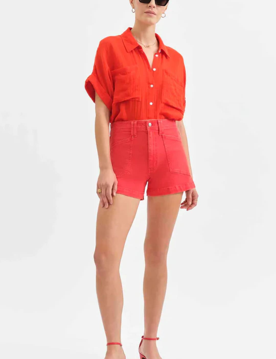 Woman in red shirt and shorts.