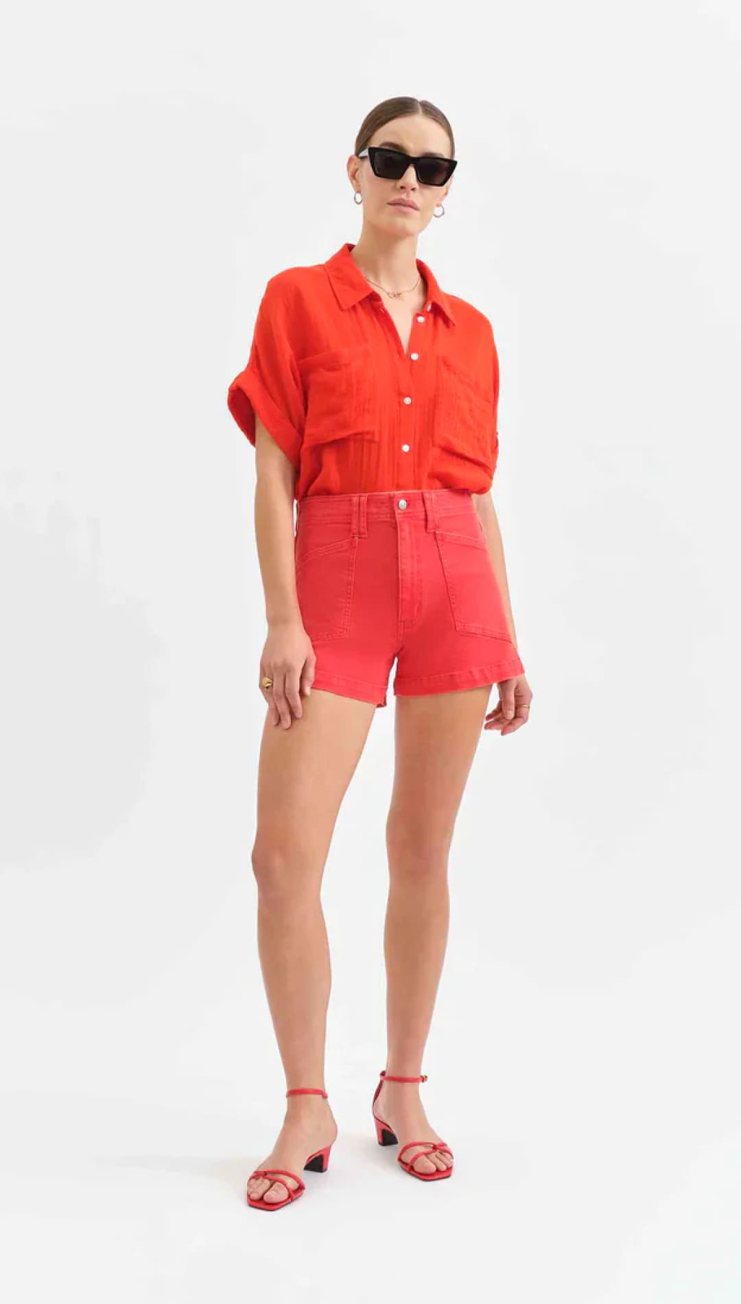 Woman in red shirt and shorts.
