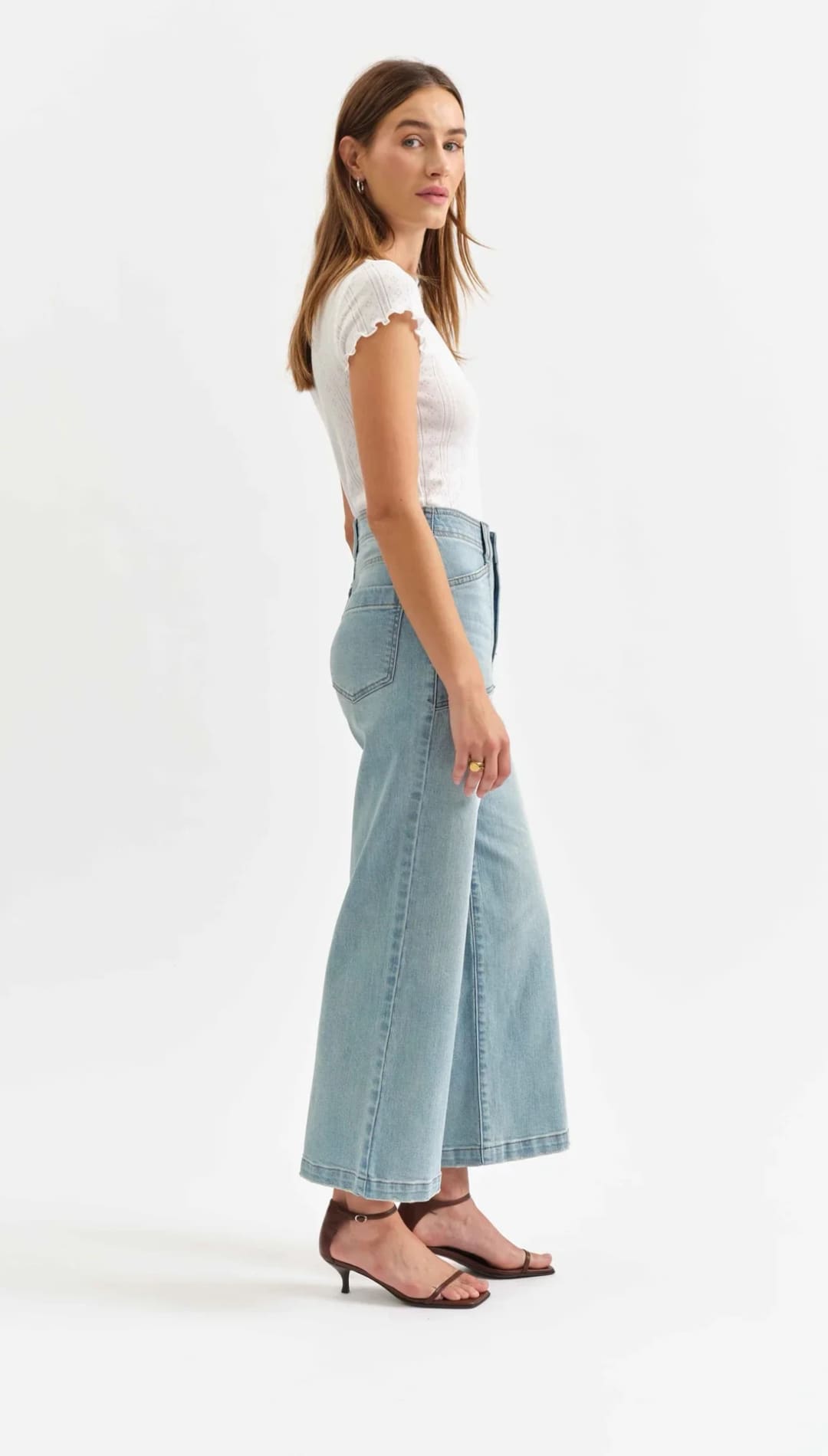 Light blue wide-leg cropped jeans paired with a white cap-sleeve top.