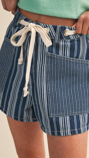 Blue and white vertically striped denim shorts with a cream-colored drawstring waistband.