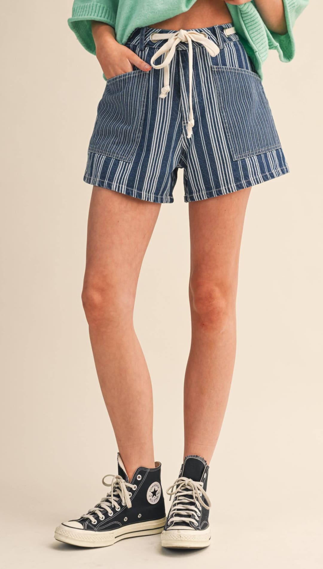 Blue and white vertically striped denim shorts with a drawstring waistband.